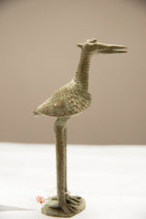 Side profile of a large African bronze stork showing its textured, patinated surface.