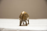 Textured back and sculpted tail of the vintage golden patina bronze rhino.