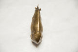 Textured golden patina on the vintage African bronze rhino's back, showing signs of age.