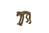 Vintage African bronze monkey sculpture with a textured spine and aged patina.