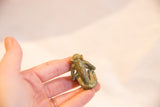 Small vintage African bronze monkey sculpture, back view, with visible patina.