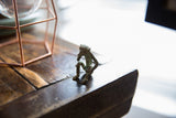 Side profile of vintage African bronze monkey, showing aged patina and handmade texture.