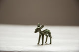 A vintage African bronze ewe showing its slender form and dark oxidized patina.