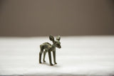 Profile view of a vintage African bronze ewe with a dark oxidized finish and textured spine.