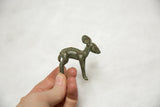 Small vintage African bronze ewe sculpture held in hand to show scale and patina.