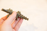 Hand-held vintage African bronze crocodile, with dark patina and textured scales.