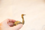 Vintage bronze ostrich in profile, highlighting the handmade texture and light patina.