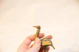 Side view of the vintage bronze ostrich sculpture showing its textured, light patina.