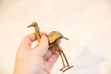 Vintage African bronze ostrich held in hand to show its textured light patina and scale.