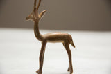 The elegant profile of a vintage copper gazelle showcasing its handmade form and aged patina.