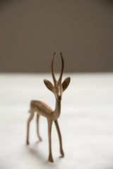 Frontal view of the vintage copper gazelle's expressive face and slender, textured horns.