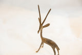 Handmade texture on the head and long straight horns of a vintage bronze gazelle.