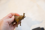 Vintage bronze elephant held to demonstrate its small, collectible scale and texture.