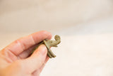 Vintage bronze elephant's head and curled trunk, showcasing handmade texture and green patina.