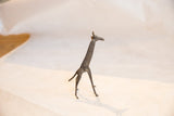 Dark patina bronze giraffe with visible handmade etched surface.