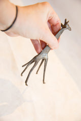 Slender vintage African dark patina bronze giraffe, revealing its handmade texture.