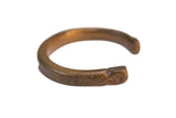 Antique African copper bracelet with a thick, C-shaped form and warm aged patina.