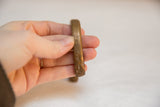 Hand-wrought texture and stamped markings on an antique African copper bracelet.