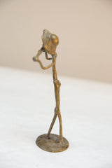 Side view of the vintage African bronze musician highlights its slender, elongated form.