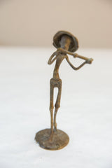 Vintage African bronze musician statue showing its slender, stylized form from an angle.