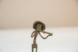 Detailed front view of the handmade bronze musician statue's head, hat, and instrument.