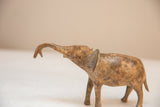 Collectible vintage African elephant sculpture, textured body, light brown patina.