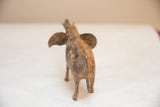 Rear view of vintage African elephant sculpture, showcasing handmade texture and light patina.