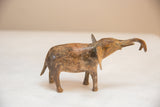 Handmade vintage African elephant sculpture with light patina and raised trunk.