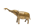 Vintage African elephant sculpture with a golden patina and its trunk raised.