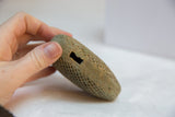 Intricate mesh pattern and rectangular hanging slot on vintage African bronze heart.