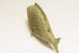 The detailed mesh pattern and oxidized patina along the spine of a vintage bronze fish.