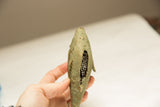 Detailed view of the textured, oxidized bronze and open meshwork on a vintage African fish sculpture.