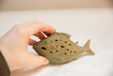 Vintage African bronze fish held in hand to illustrate its scale and wire-work details.
