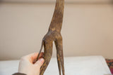 Rear view of the vintage bronze giraffe highlighting its aged patina and slender tail.