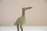 Textured, oxidized patina on the head and long neck of a vintage African bronze stork.