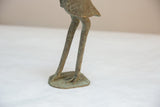 Textured legs and oxidized base of the vintage African bronze stork sculpture.
