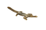 Vintage handmade African crocodile sculpture, gold-toned with black-backed patina and curved tail.