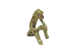 Vintage handmade African sitting monkey sculpture in oxidized bronze with a greenish patina.