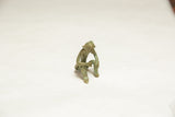 The contemplative pose and aged patina of a vintage bronze monkey figurine.