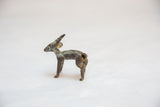 Vintage African impala sculpture, dark bronze with textured green patina, in profile.