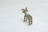 Handmade texture and oxidized green patina on the back of a vintage African ram sculpture.
