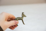 Vintage African bronze ram figurine held to show its small, collectible scale and texture.
