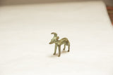 Handmade vintage African ram showing its forward horns and textured, oxidized body.
