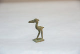 Side view of a vintage African bronze stork with a textured, weathered patina.