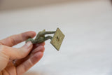 View of the square base on the vintage bronze stork, showing its oxidized, textured patina.
