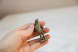 Back view of the small African warrior showing its oxidized patina.