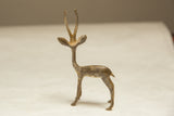 Three-quarter view of a vintage gazelle sculpture with a light, time-worn patina.