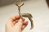 In-hand view of a vintage African gazelle showing its size and light patina.