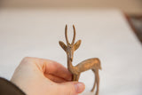 Handmade details of the vintage metal gazelle's face, horns, and golden patina.