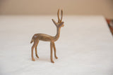 Side view of a vintage golden patina gazelle, showing its handmade form and texture.